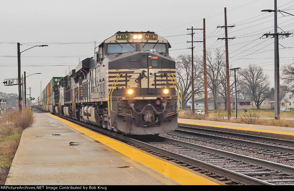 NS 7663 leads westbound stacks through South Bend Amtrak station